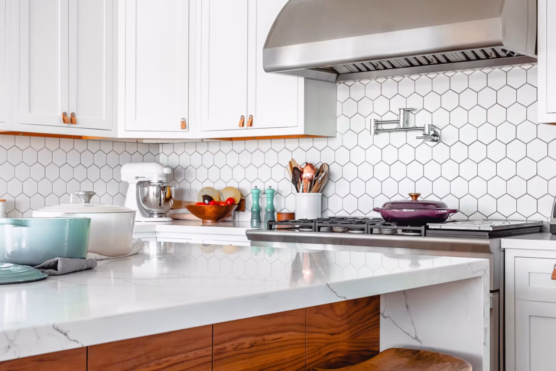 White kitchen remodel with hex tile backsplash and marble counters by GIL Renovation Services.